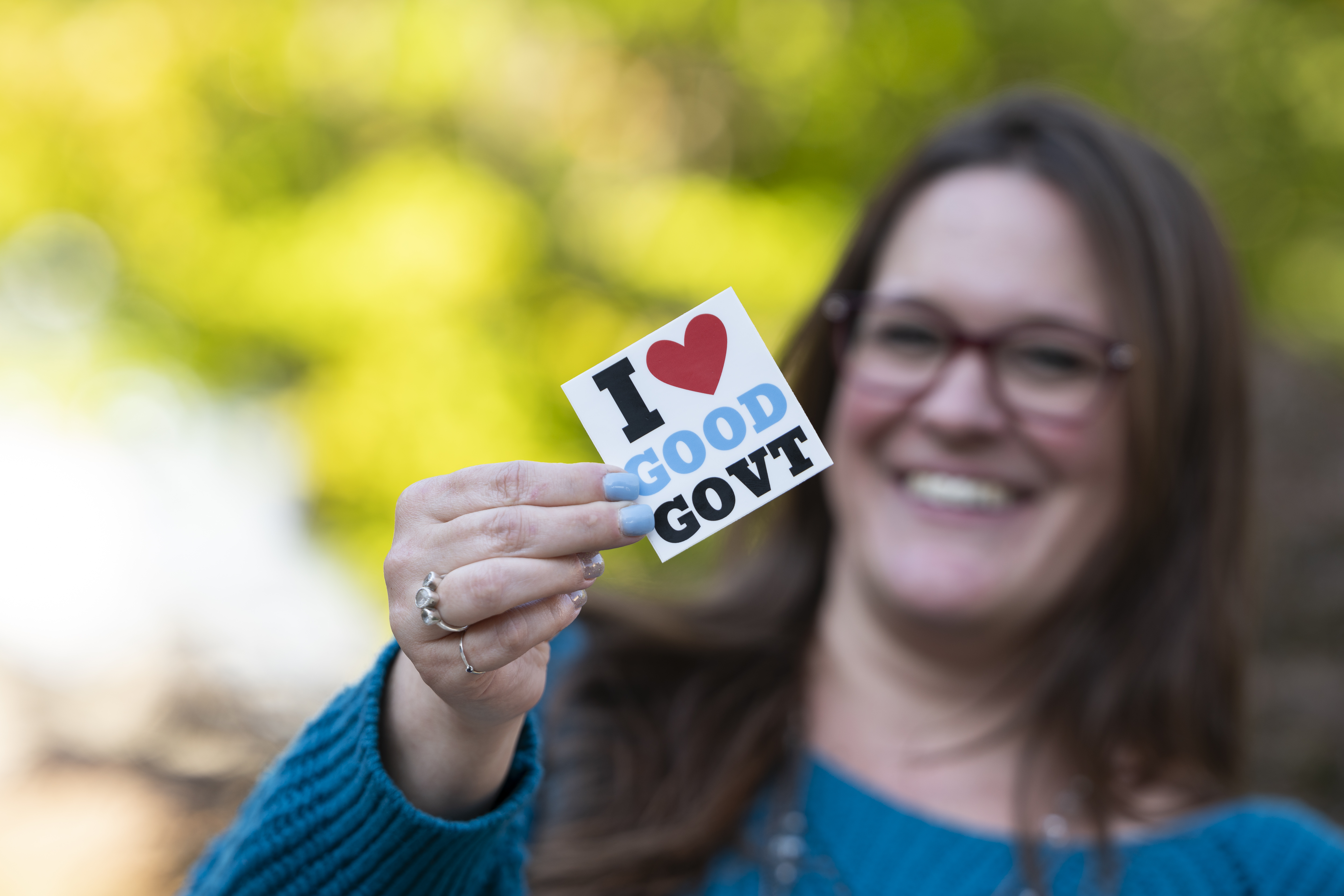 MPA student holds "I love good government" sticker